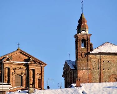 Historic center of La Morra Italy with cobbled streets and old houses with snow