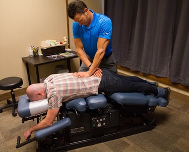 a man is doing a massage on a man's back