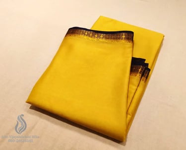Bright yellow silk saree with elegant gold and black border, perfect for festive occasions.