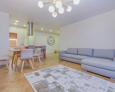a living room with a couch and a clock