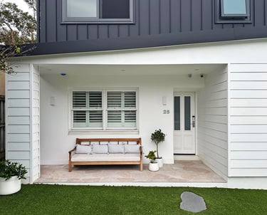 Architect-designed family home featuring a bold Hampton Brutalist exterior with matte black and white contrast.