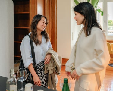 Two women sharing a conversation during a fertility support event.