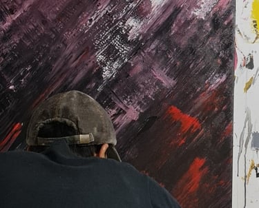 a man is painting a large painting on a canvas