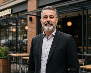 business owner standing in front his restaurant