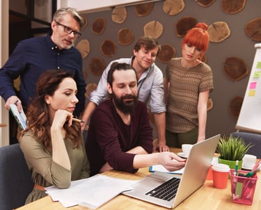 team collaboration photo where professionals are brainstorming, sketching, or working on a website project.