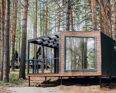 a tiny cabin in the woods with a bicycle