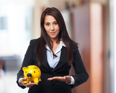 a woman in a suit and tie holding a piggy bank