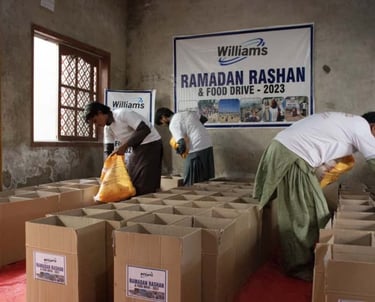 a group of people standing around boxes of food
