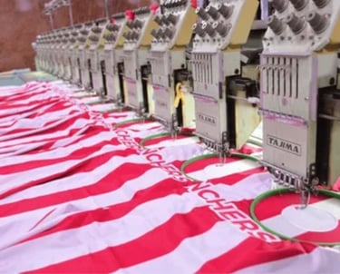 a row of sewing machine with a red and white striped shirt