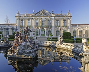 a fountain with statues and statues in front of a large building
