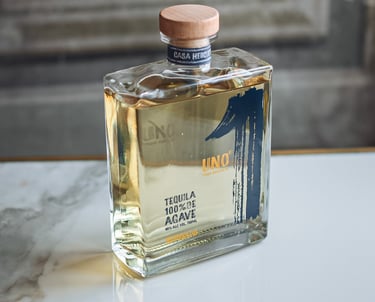 a bottle of Tequila Uno Reposado - premium tequila reposado