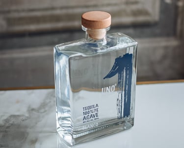 a bottle of Tequila Uno Blanco - premium tequila blanco