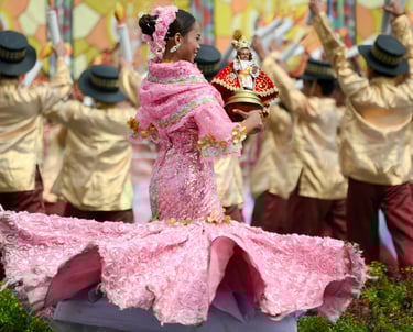 a woman dancing the Sinulog