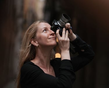 A blonde woman photographer capturing photos with a professional camera in Gothic Quarter