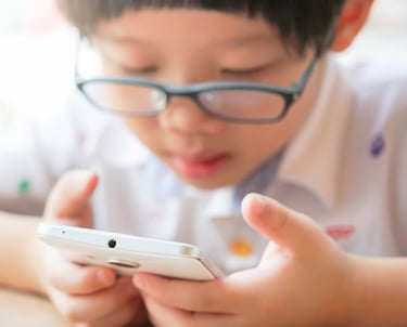 child reading letters in phone