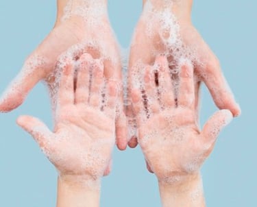 two hands holding soap and soap on a blue background