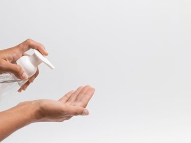 a person holding a bottle of liquid in their hand