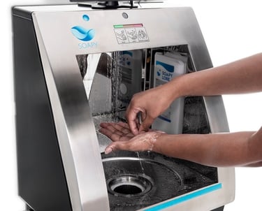 a person washing their hands in a machine