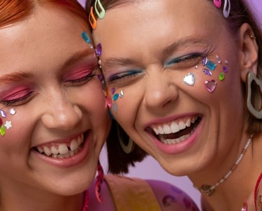 two women with colorful makeup and face paint