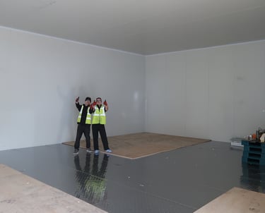 Happy colleagues in a giant freezer room in London