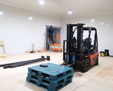 Perspective shot of a cold storage facility with heavy machinery inside, emphasizing the size and in
