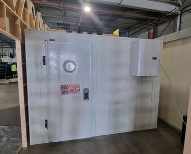 A freezer room with straddle unit