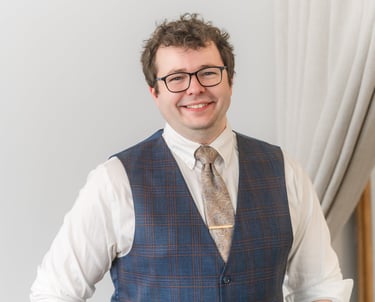 Portrait of Rocco Catrone in vest and tie.