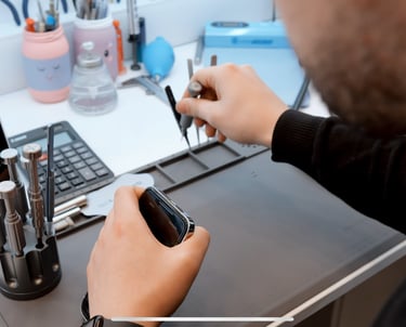 a man is holding a cell phone in his hand