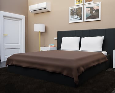 a bed room with a bed and a lamp