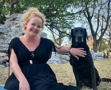 Sunni Dawson smiling with a black Labrador during animal communication session
