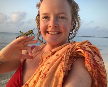 Sunni Dawson smiling with a cricket post rescue on beach