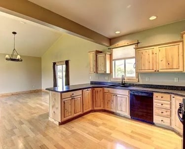 Custom wood floors and trim with black grnaite counter tops in this custom luxury home