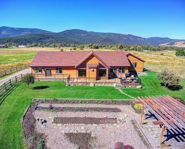 26205 sliding Horse Ln - Aerial House with Montana mountains -Saddle Horn Custom Homes