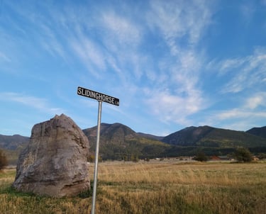 Slidinghorse Ln street sign near Arlee, MT with the Mission Mountains