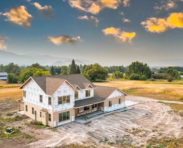 a large house being built with a Montana valley in the background