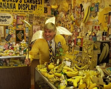 a man in a yellow shirt and a banana peeler