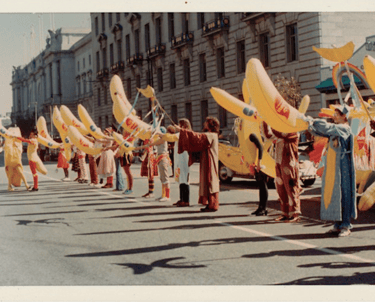 a group of people holding up yellow umbrellas