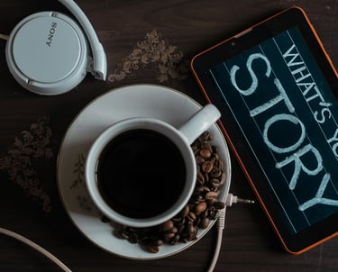 a tablet with a cup of coffee and headphones