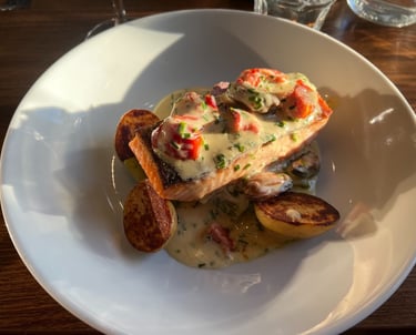 a plate of food with potatoes and salmon on it