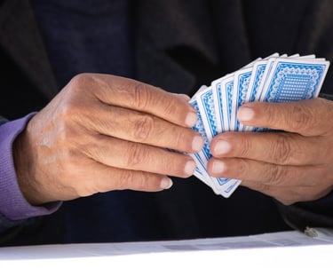 Person holding playing cards