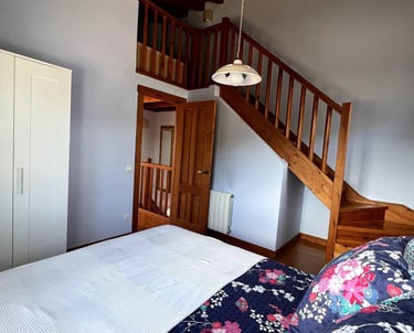 a bed with a bed and stairs leading to a staircase