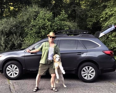 The author with his dog, Vinnie, in front of his Subaru Outback