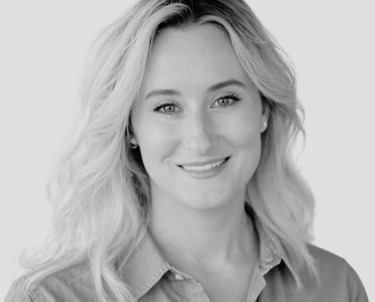 a picture of Kate Newman in a collared shirt smiling at the camera