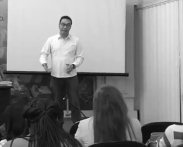 a man standing in front of a presentation on a presentation