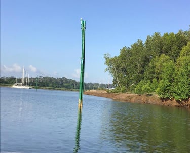 a boat on the water with a pole sticking out of it