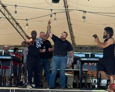 Champion arm wrestler raises his arm in victory 