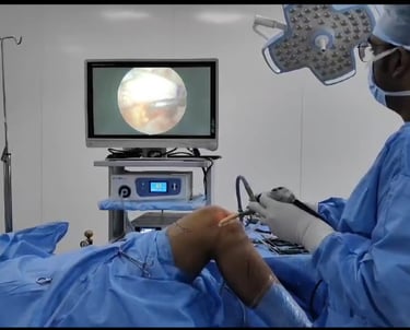 Surgeon performing minimally invasive arthroscopic surgery on a patient's knee.