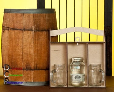 A scene depicting a wooden barrel and box with and a glass jars