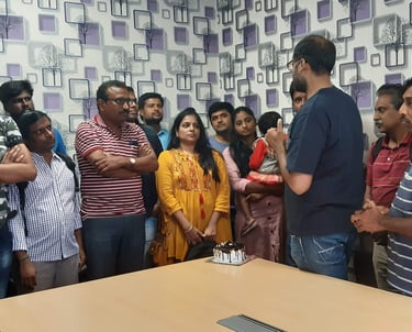 a group of people standing around a table