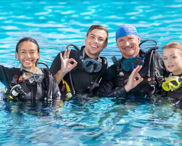 a group of people in scuba gear standing in the water